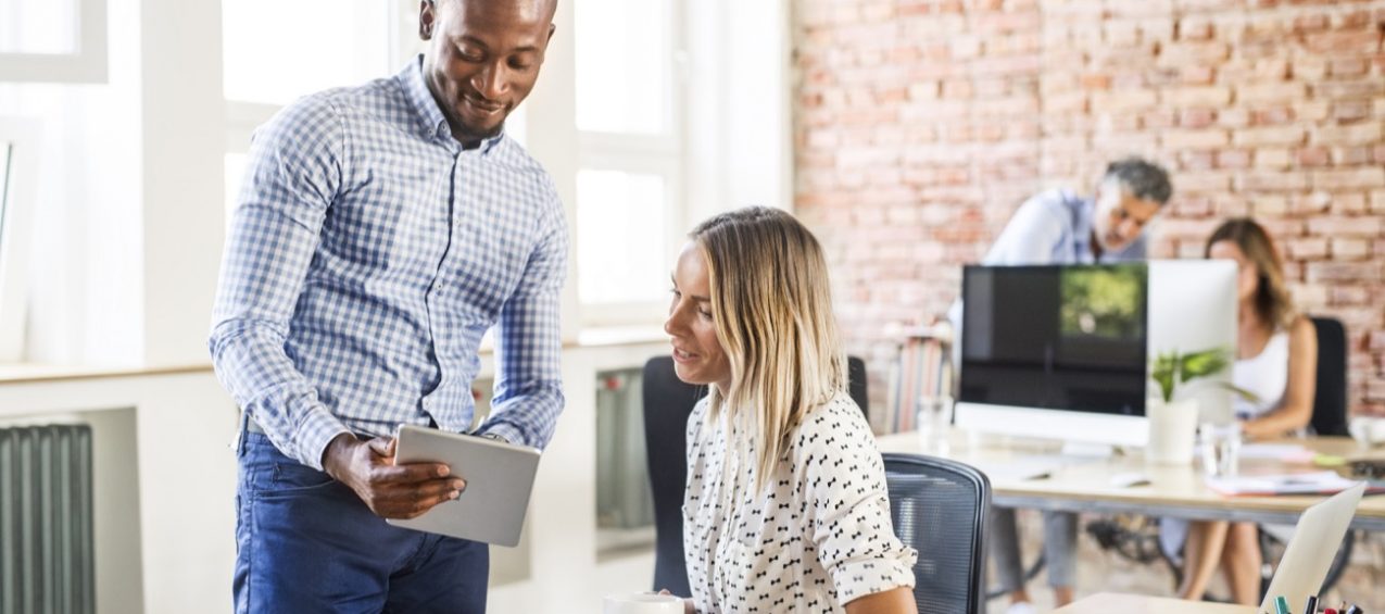Real estate professionals discussing property transaction documents