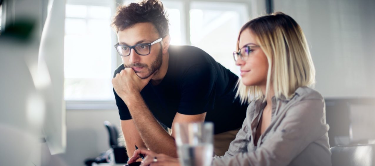 Technology team collaborating around connected business systems